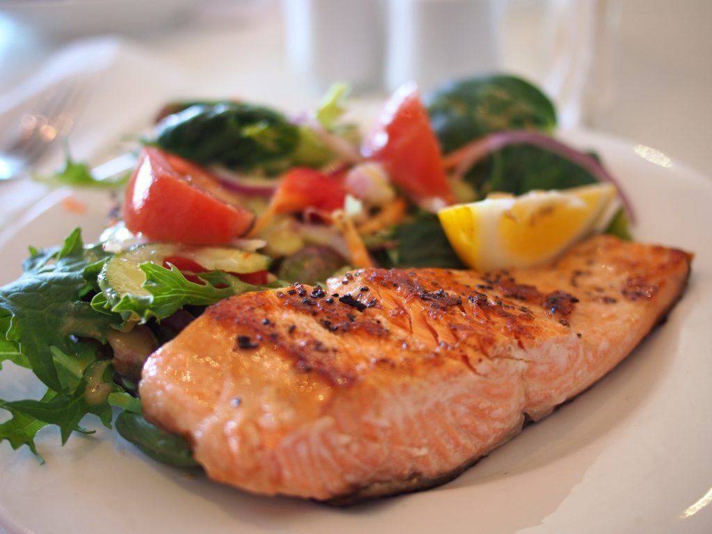 salmon with salad on a plate