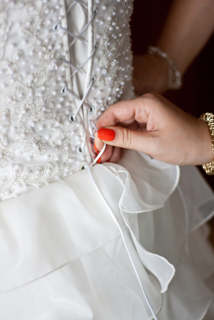 hand tying wedding dress